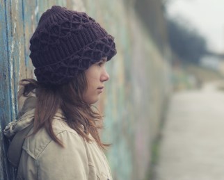 Portrait of lonely teenage girl on moody winter day.